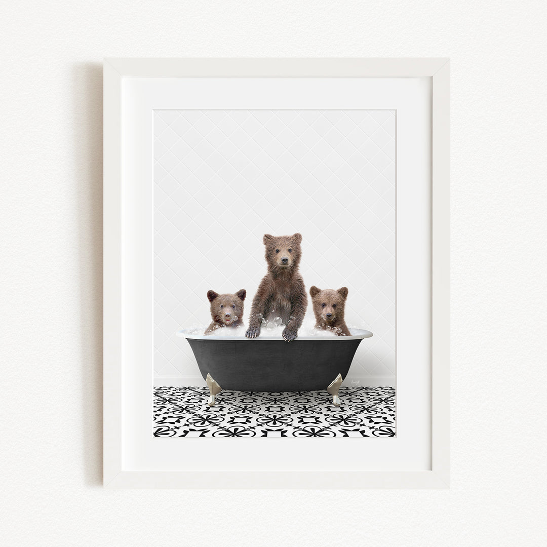 A framed image depicting three adorable brown bears sitting in a bathtub, with one bear standing on its hind legs and the other two sitting comfortably.