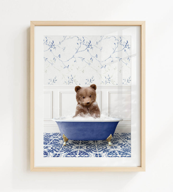 A brown bear sitting in a blue bathtub filled with bubbles, surrounded by a blue and white patterned floor.