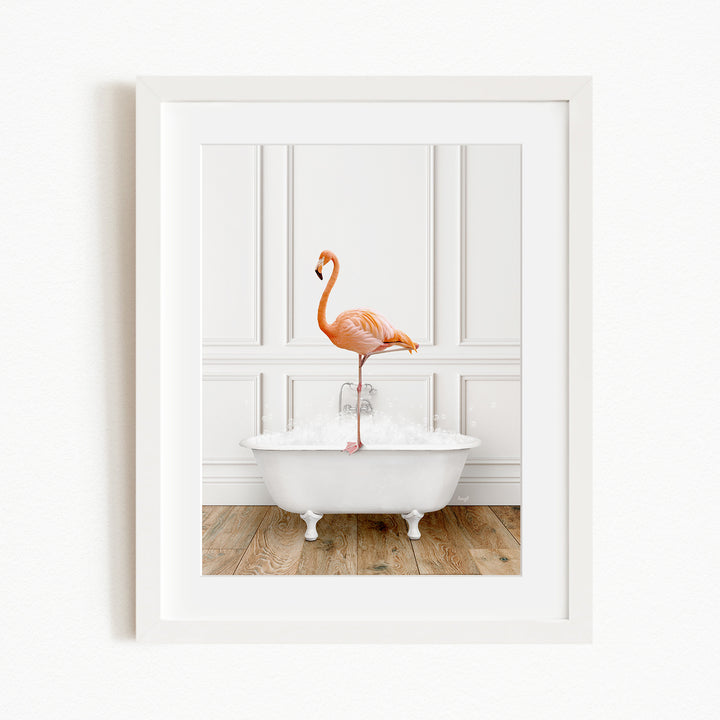 A pink flamingo standing on the edge of a white claw-foot bathtub, with a white wall and wooden floor in the background.