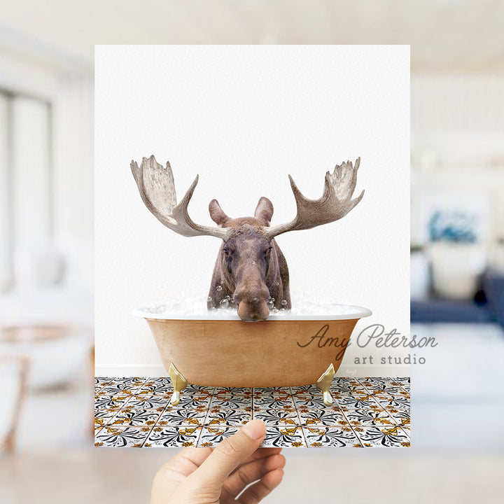 a hand holding a card with a moose in a bathtub