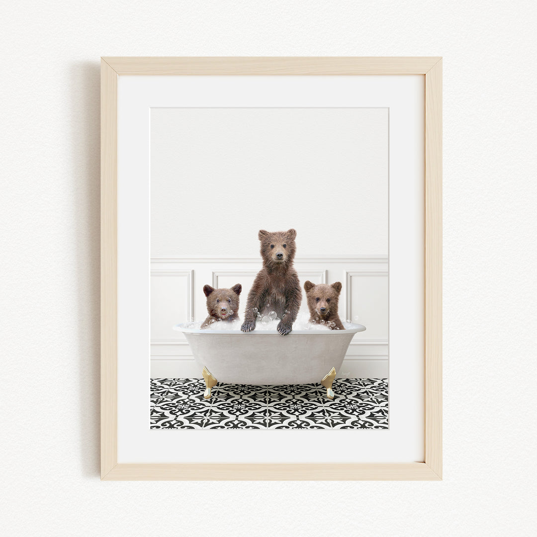 A framed image depicting three bears sitting in a bathtub, with one bear sitting in the center and the other two bears sitting on either side.