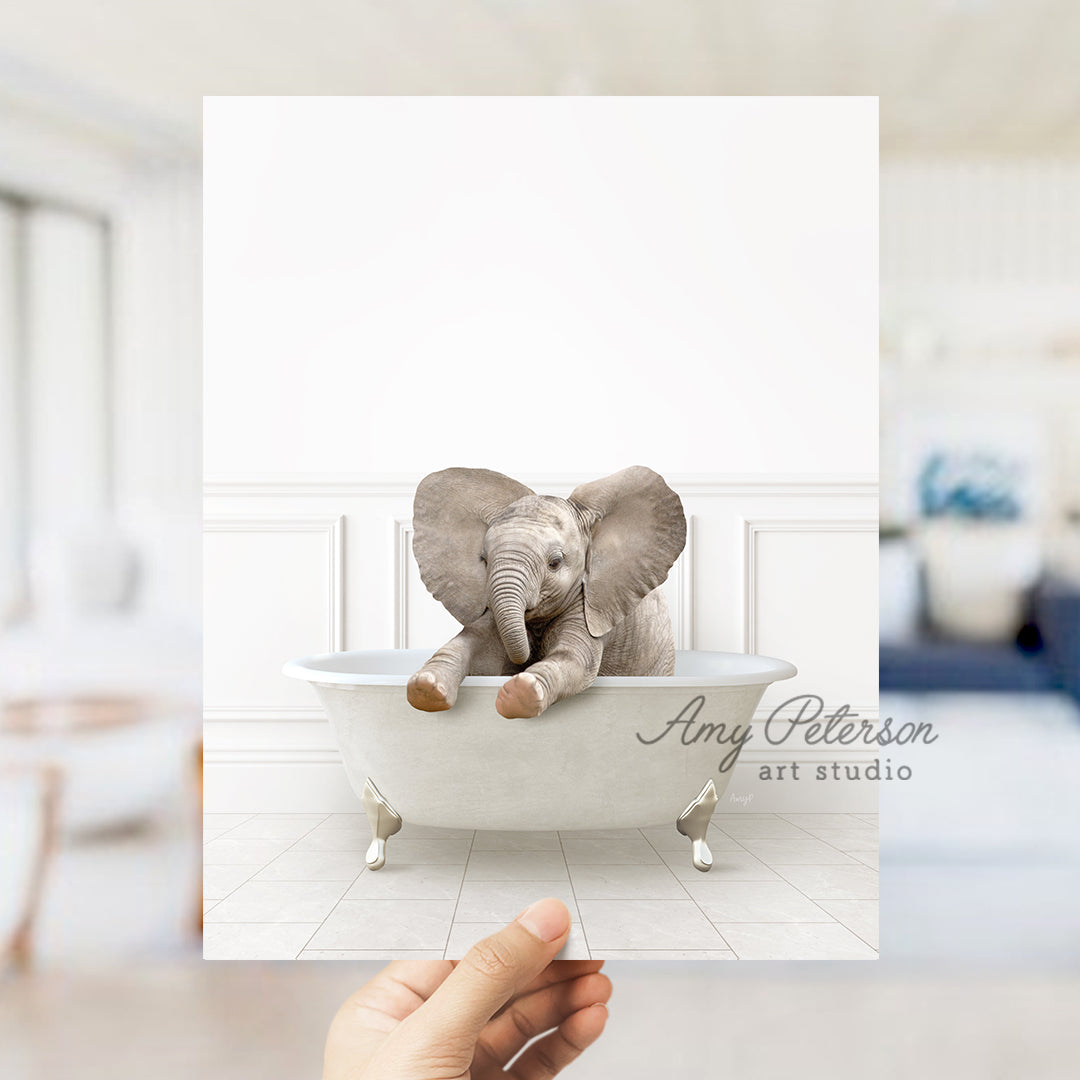 a person holding up a card with an elephant in a bathtub