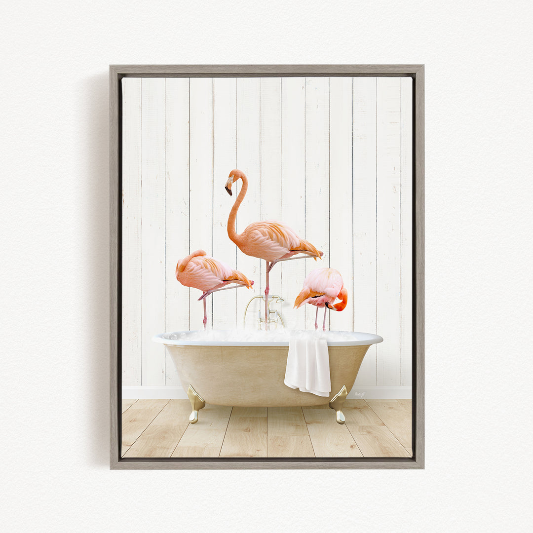 A framed image depicting three flamingos standing on the edge of a bathtub filled with water, creating a whimsical and playful scene.