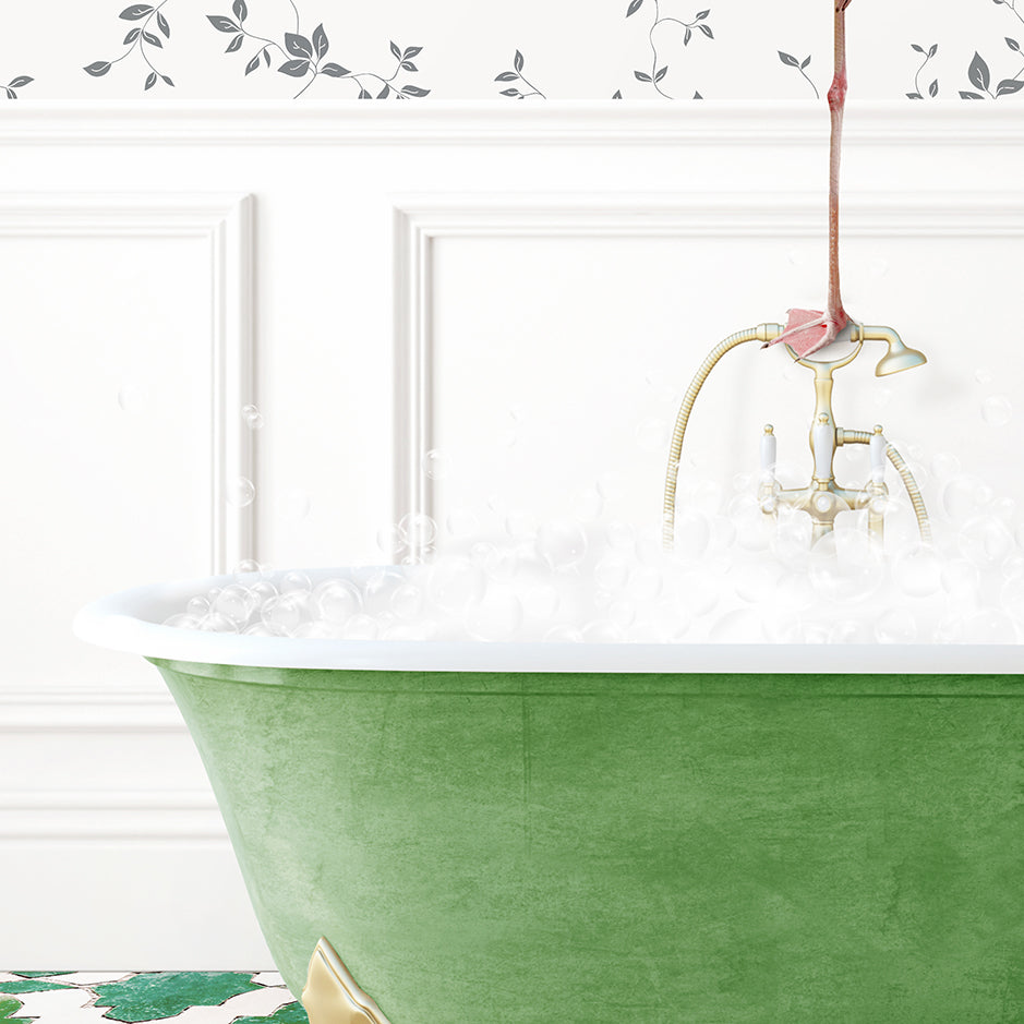 a green bathtub filled with foam and a pink flower