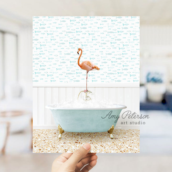 a person holding up a picture of a flamingo in a bathtub