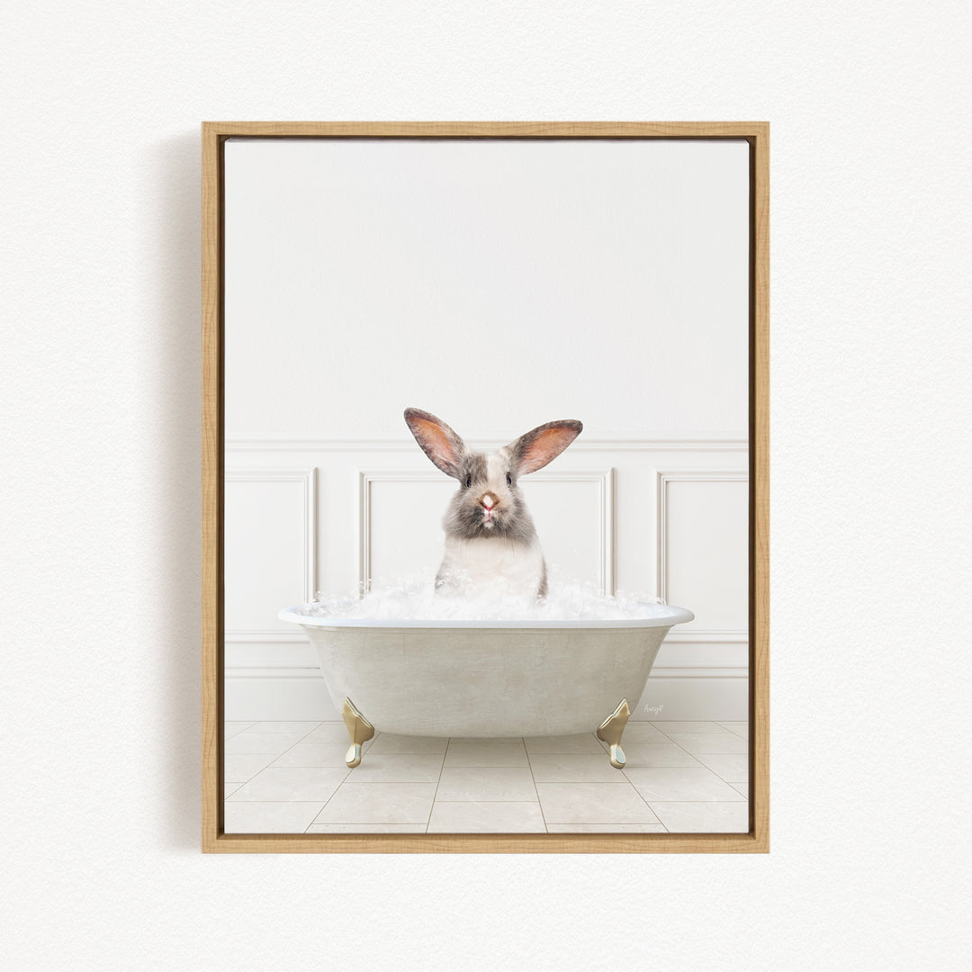 A white rabbit sitting in a white bathtub filled with water, looking directly at the camera.