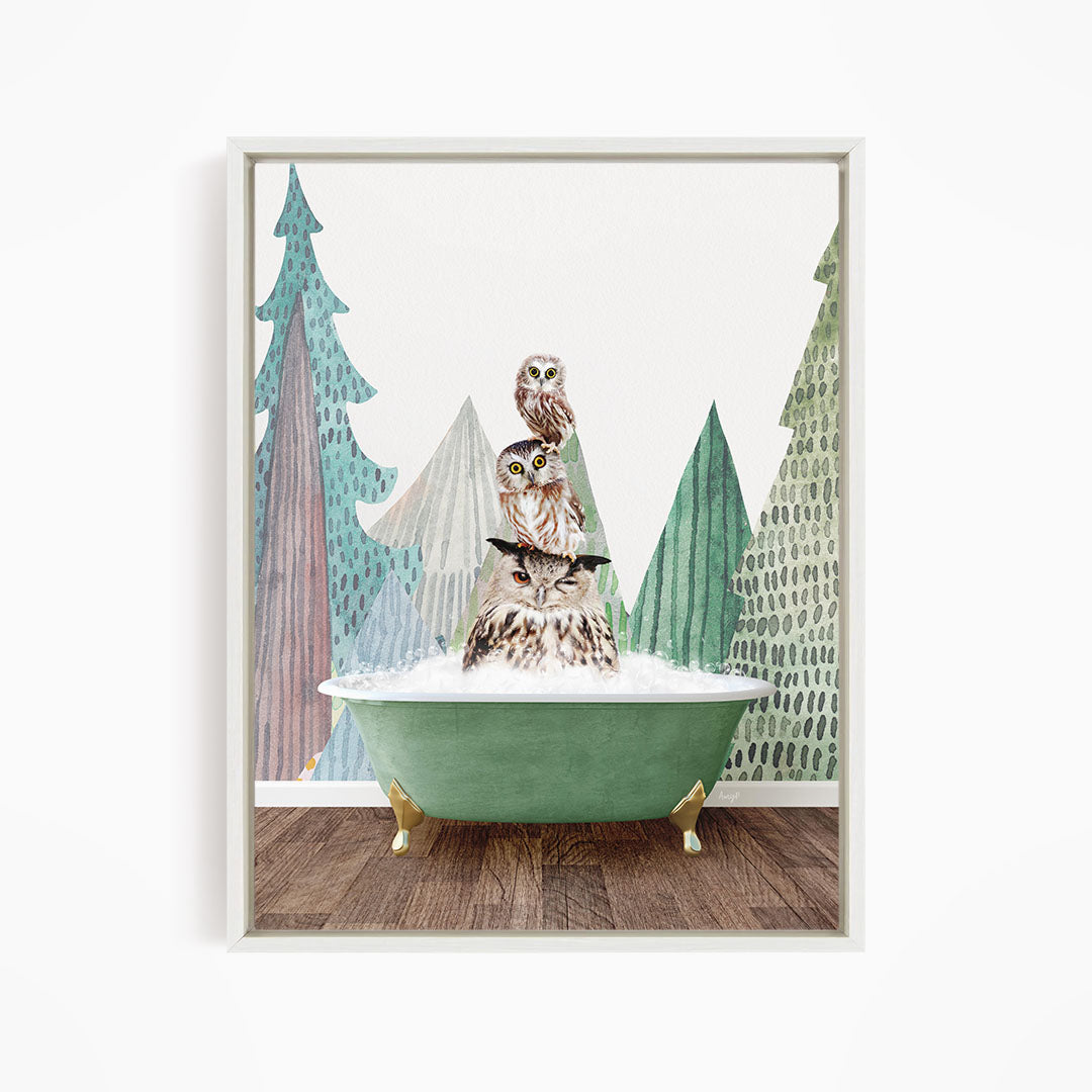 A framed print depicting a whimsical scene of two owls sitting in a green bathtub, surrounded by stylized trees and a snowy landscape.