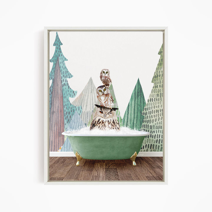 A framed print depicting a whimsical scene of two owls sitting in a green bathtub, surrounded by stylized trees and a snowy landscape.
