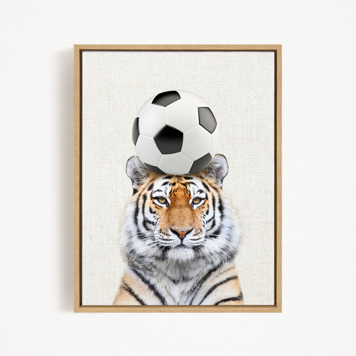 A tiger is depicted balancing a soccer ball on its head, creating a playful and amusing scene.