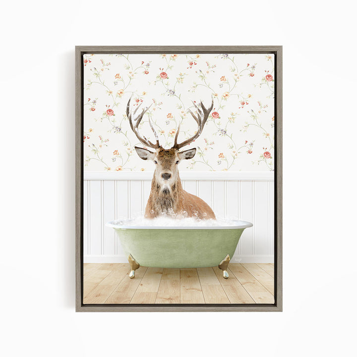 A deer with large antlers is sitting in a green bathtub, surrounded by a floral wallpaper.