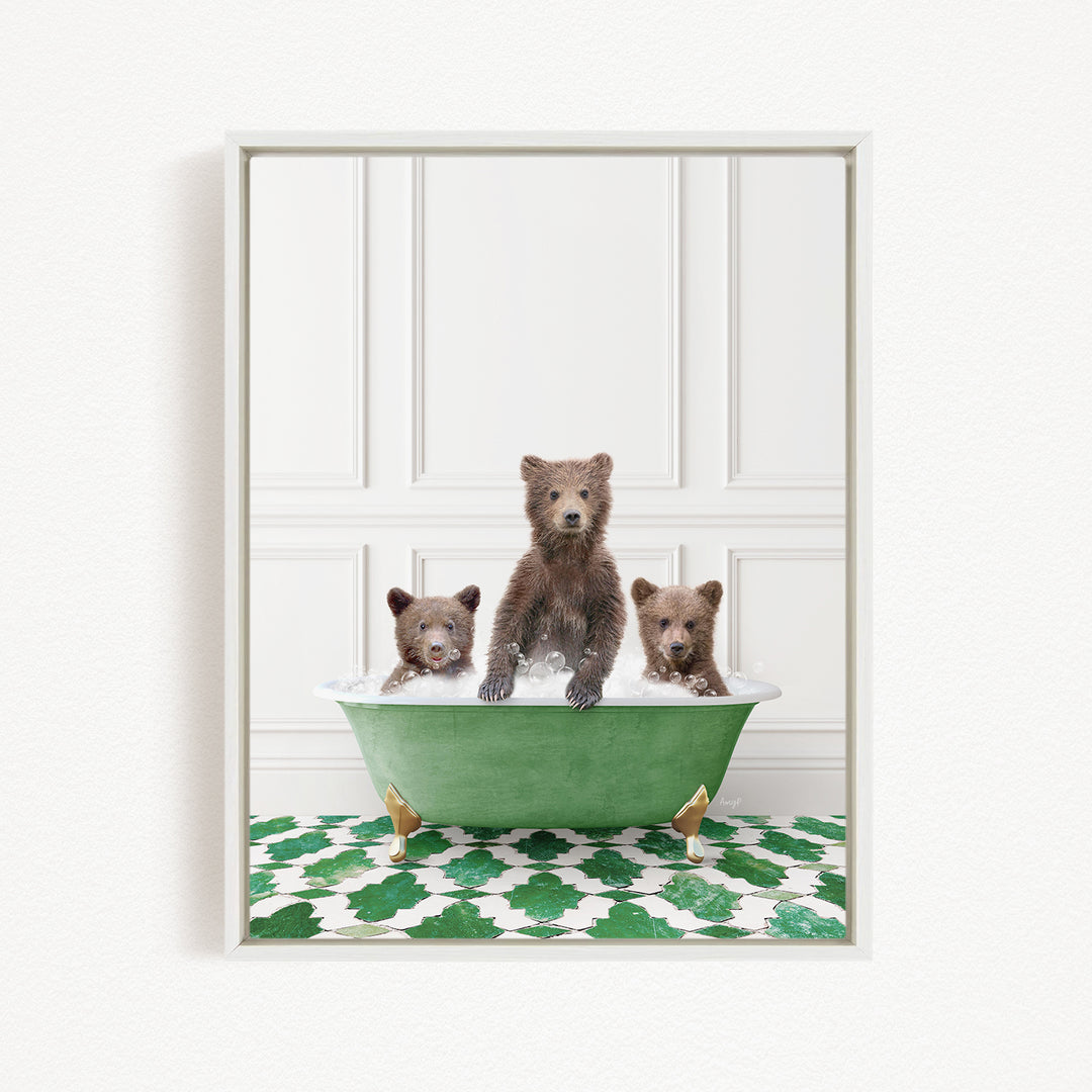 A framed image depicting three brown bears sitting in a green bathtub, with a patterned green and white floor beneath them.