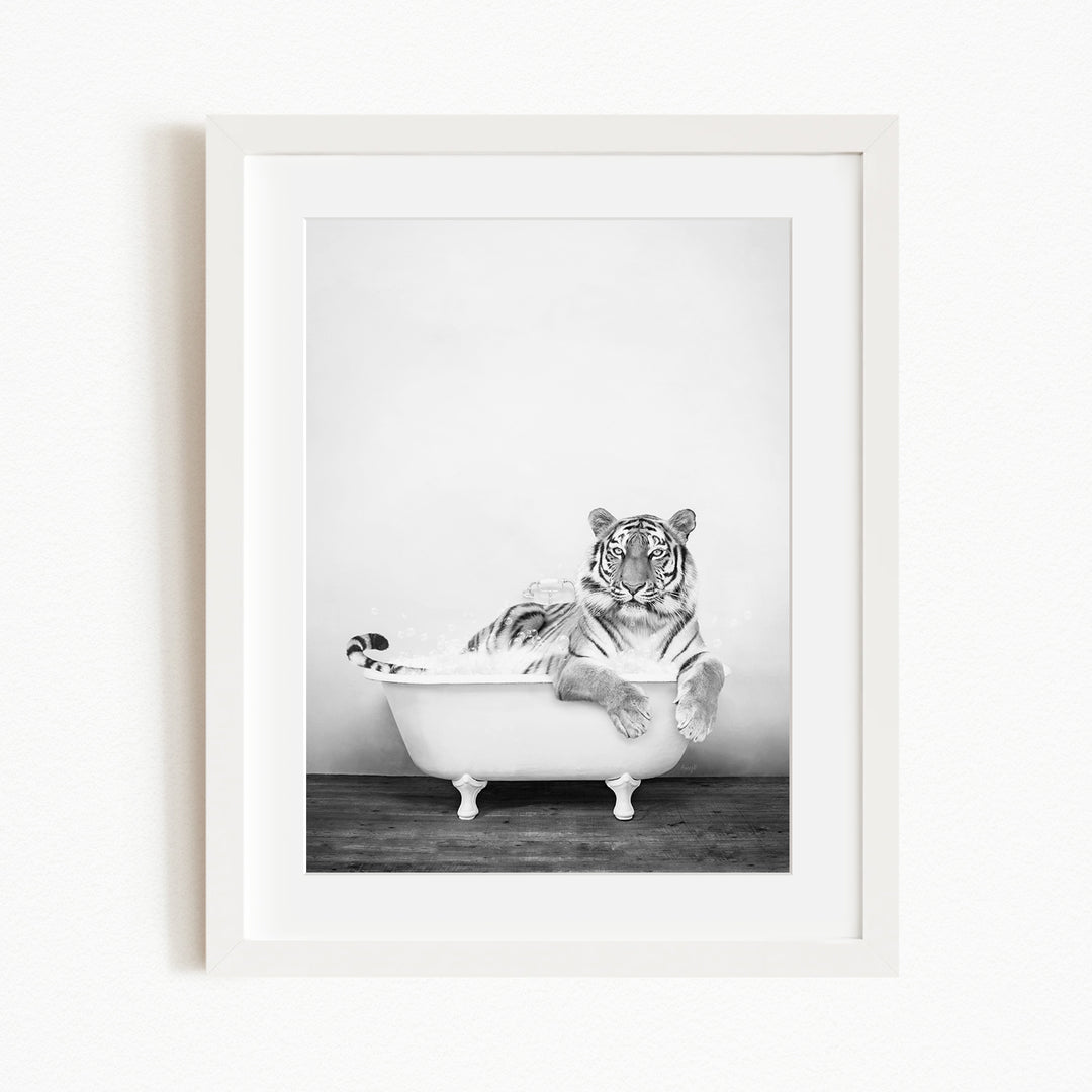 A tiger is sitting in a bathtub filled with water, appearing relaxed and enjoying the experience.
