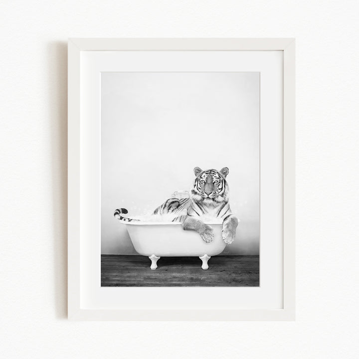 A tiger is sitting in a bathtub filled with water, appearing relaxed and enjoying the experience.