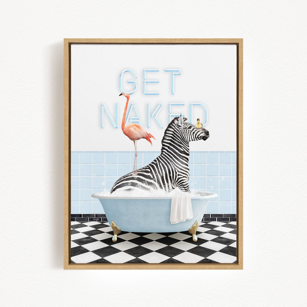 A framed print featuring a zebra sitting in a bathtub with a flamingo standing on its back, and the text "GET NAKED" written above them.