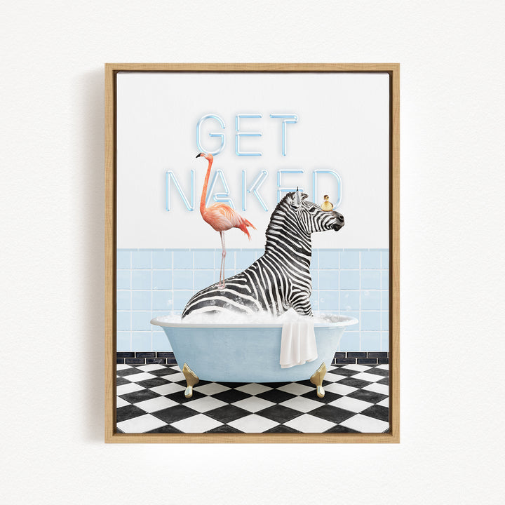 A framed print featuring a zebra sitting in a bathtub with a flamingo standing on its back, and the text "GET NAKED" written above them.