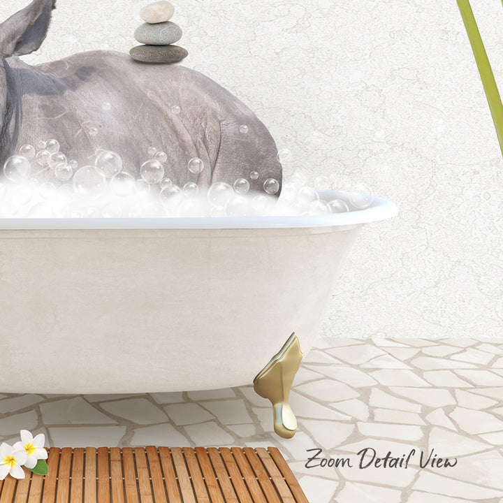 A white bathtub filled with bubbles, with a rhinoceros standing inside it.