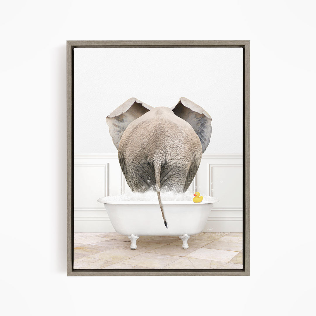 An elephant is standing in a white bathtub filled with water, with a rubber duck floating nearby.