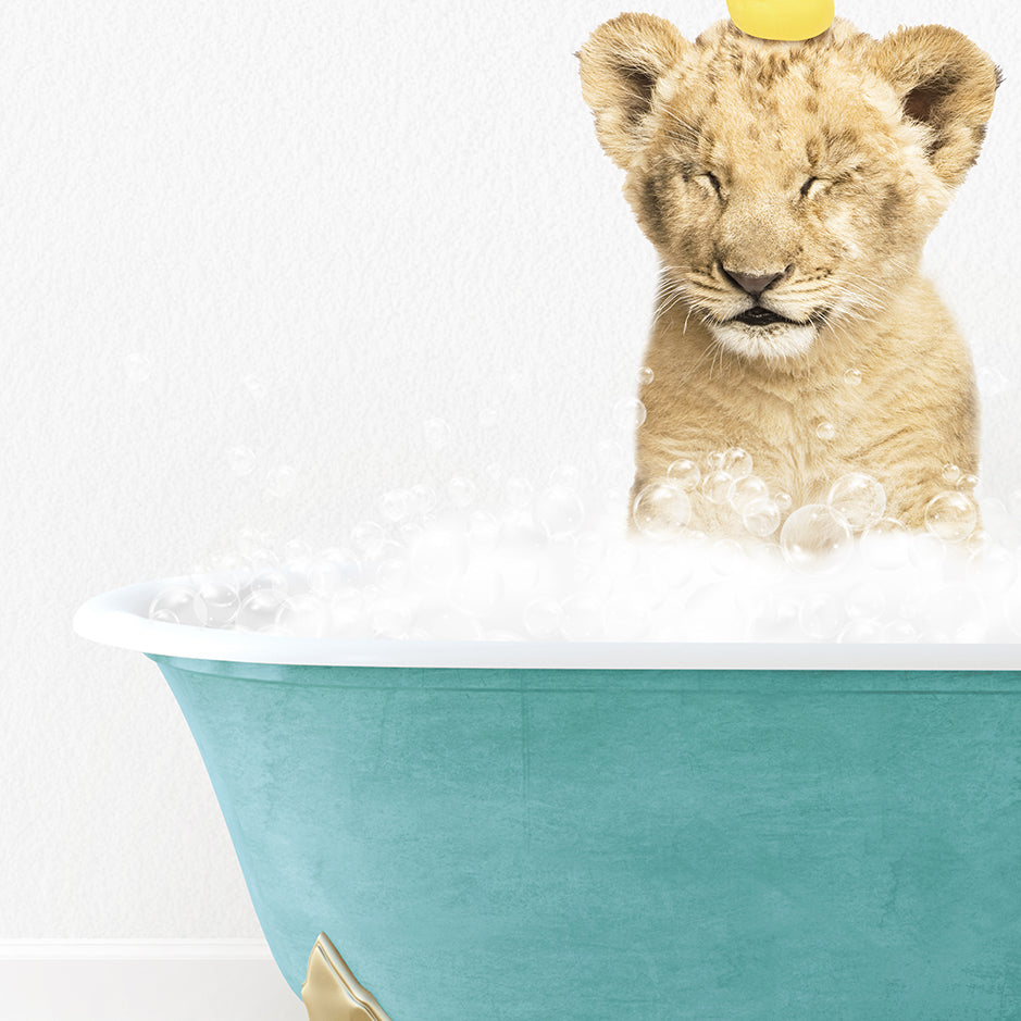 a lion cub sitting in a bathtub with bubbles