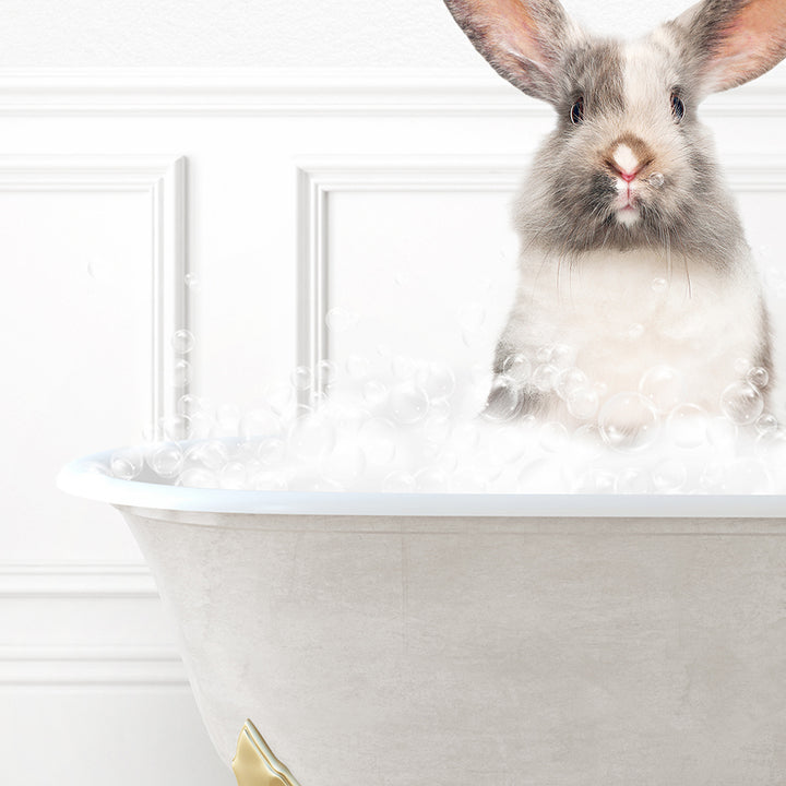 a rabbit is sitting in a bathtub with bubbles