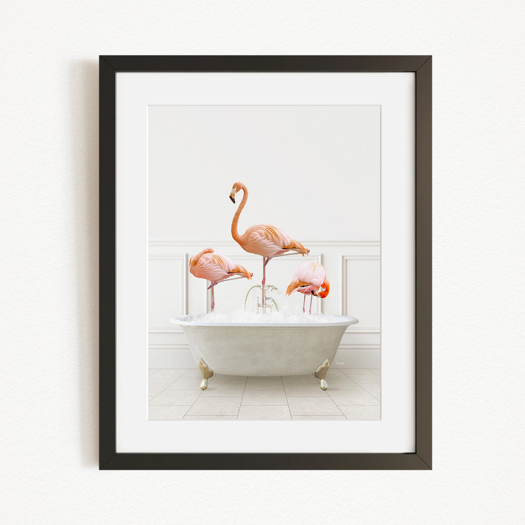 A framed image depicting three flamingos standing in a white bathtub filled with water.
