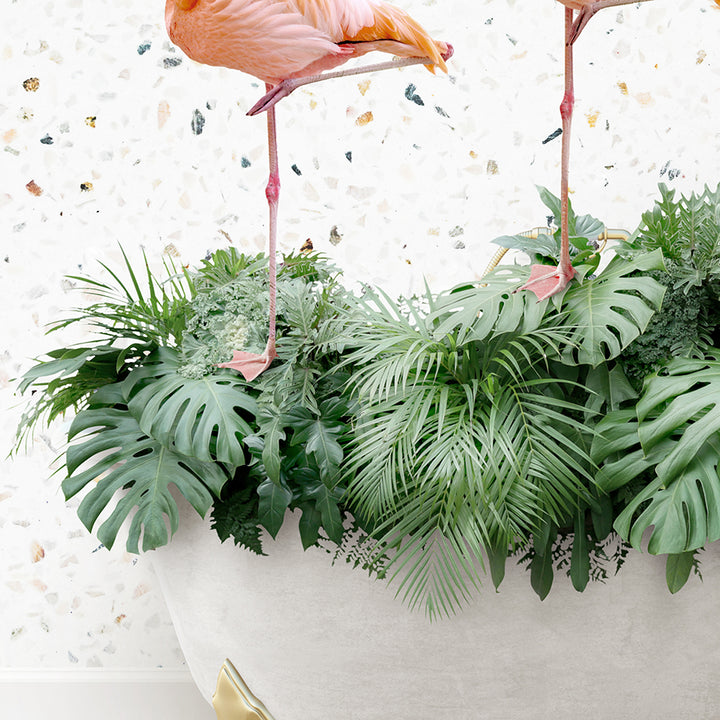 two flamingos are standing on top of a planter