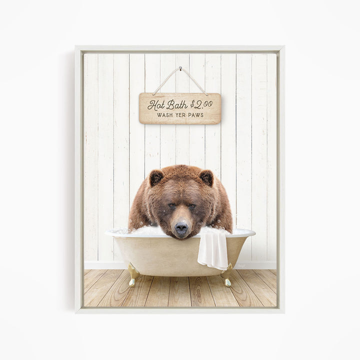 A brown bear relaxing in a bathtub, with a sign above that reads "Hot Bath $2.00 WASH YOUR Paws".