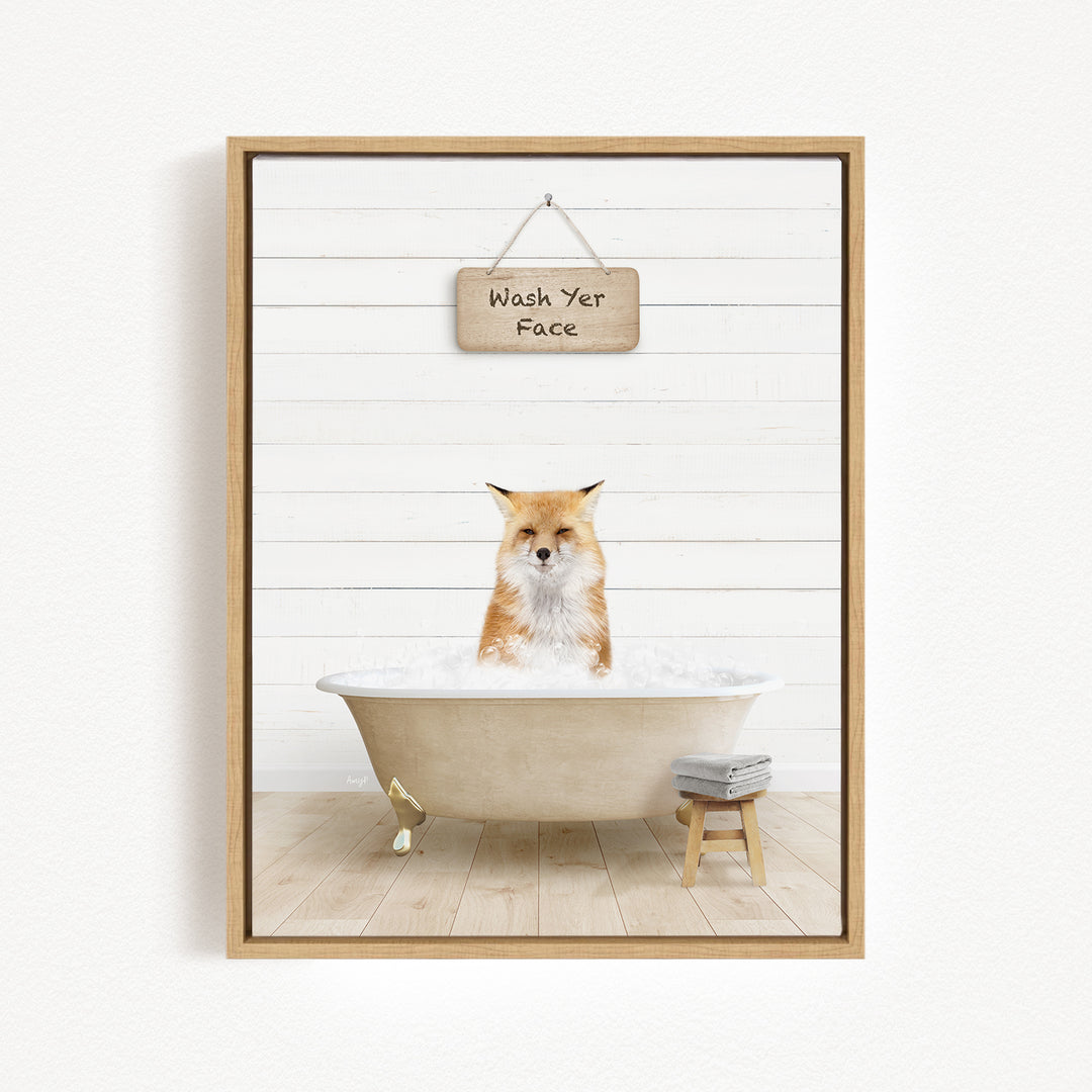 A framed image depicting a fox sitting in a bathtub, with a sign above that reads "Wash Your Face".