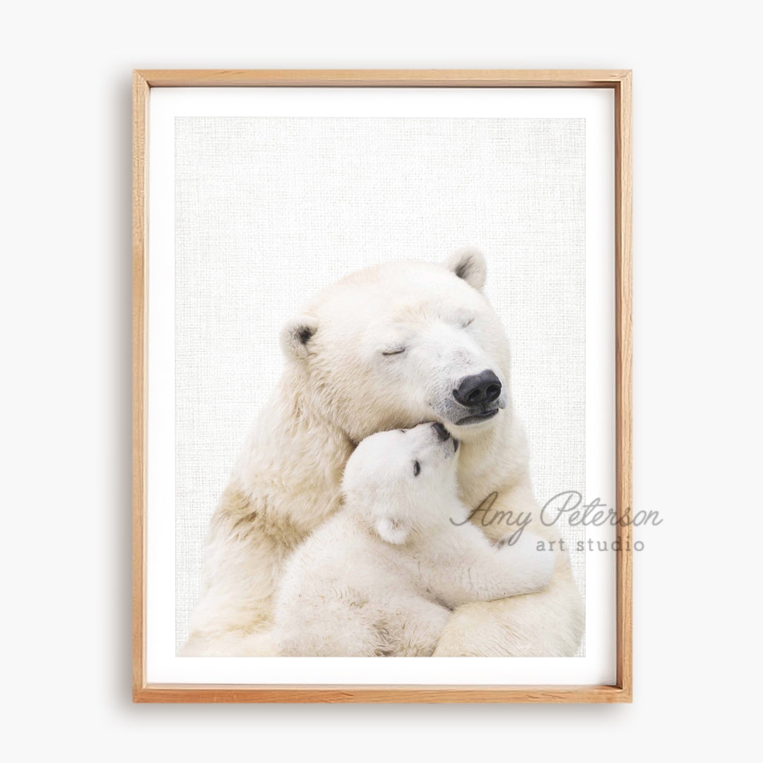 a polar bear holding a baby polar bear