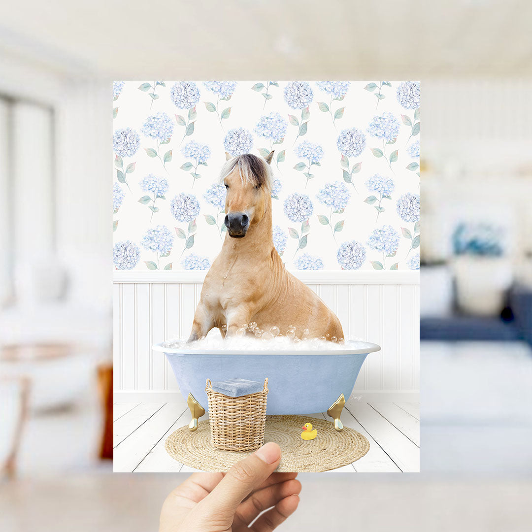 A brown horse sitting in a blue bathtub filled with water, surrounded by a wicker basket and a rubber duck.