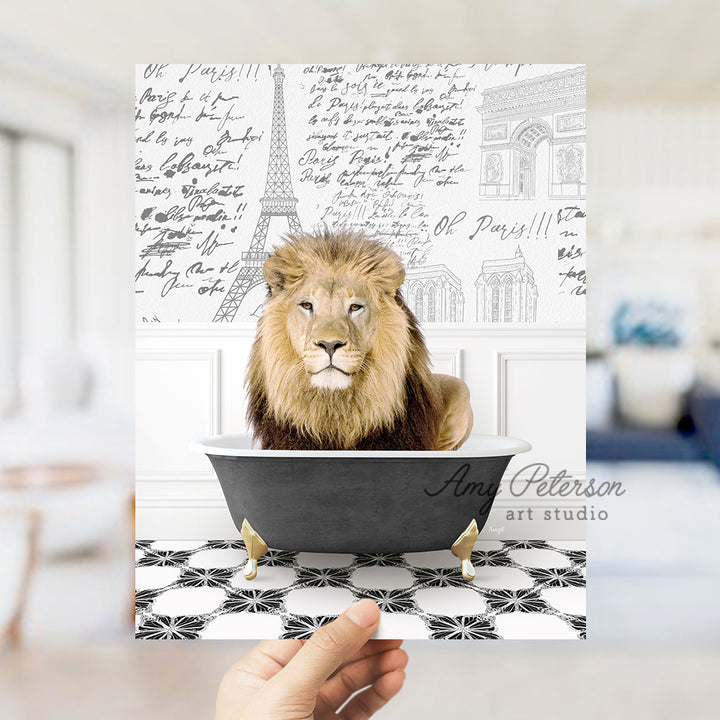 a hand holding a card with a lion in a bathtub