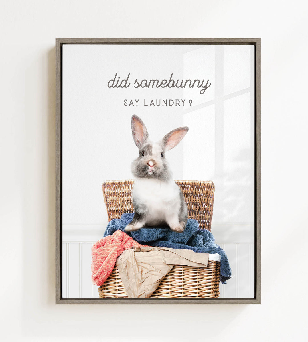 A cute rabbit sitting in a wicker basket filled with clothes, with the text "Did some bunny Say laundry?" displayed above the image.
