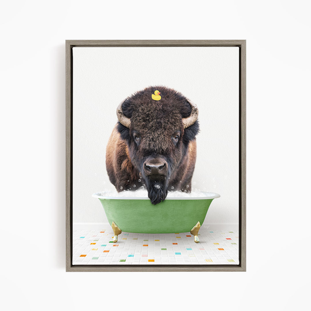 A buffalo with a yellow rubber duck sitting in a green bathtub.
