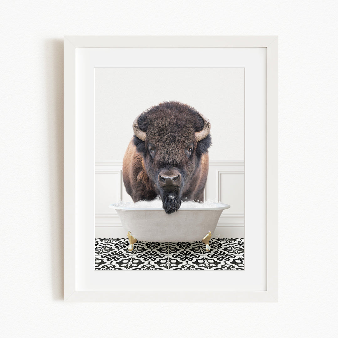 A buffalo with large horns is standing in a white bathtub filled with water, creating a whimsical and humorous scene.