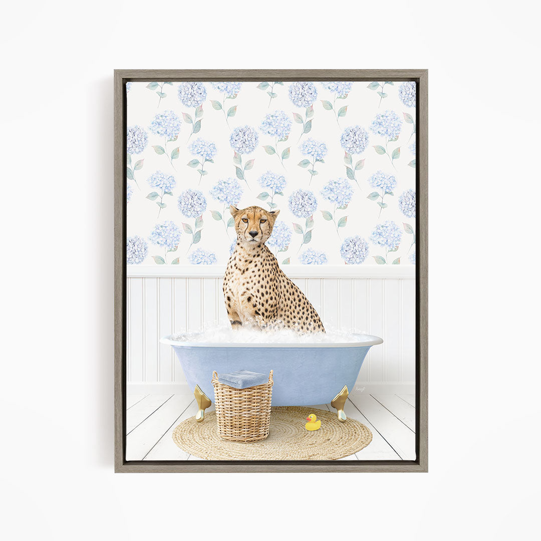 A cheetah sitting in a blue bathtub filled with water, surrounded by a wicker basket and rubber ducks.