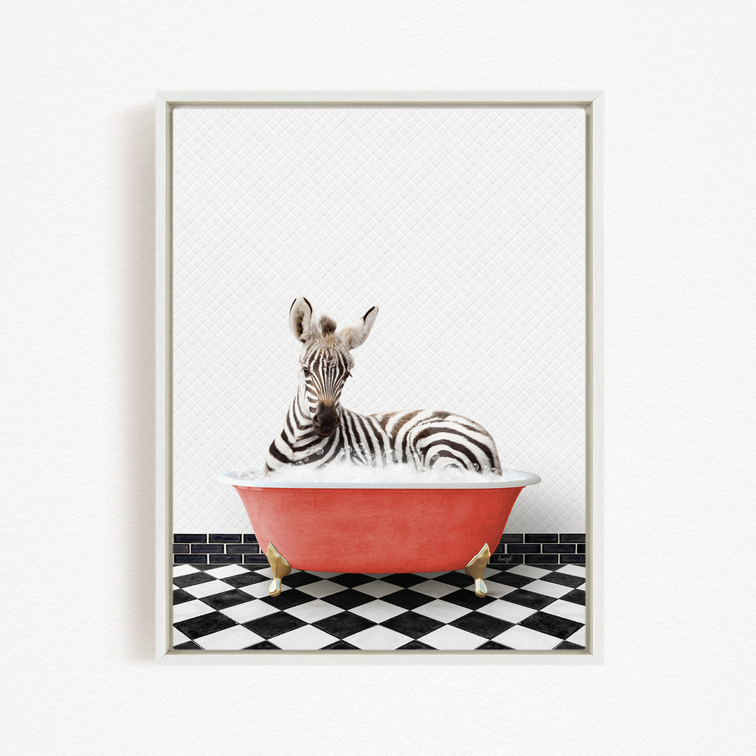 A zebra is sitting in a red bathtub on a black and white checkered floor.