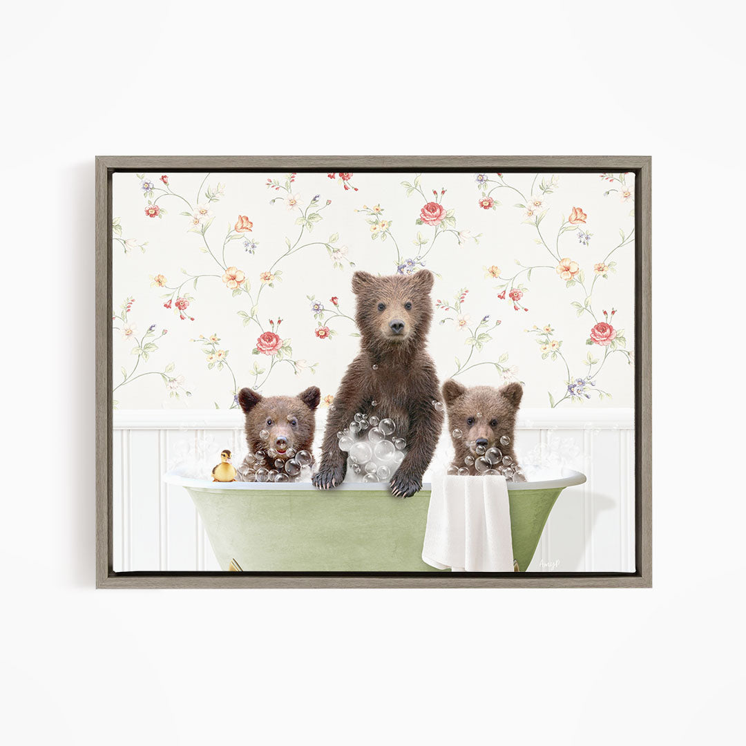 Three adorable brown bears sitting in a green bathtub, surrounded by a floral patterned wall.