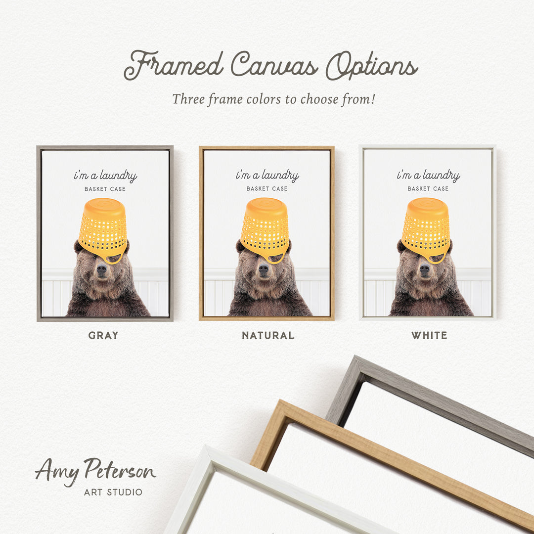 The image is a framed canvas with three different color options for a laundry basket case, each featuring a bear wearing a yellow bucket hat.
