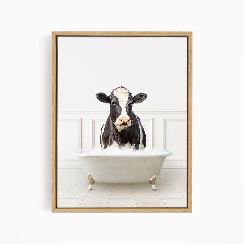 A black and white cow is standing in a white bathtub filled with water, creating a whimsical and humorous scene.