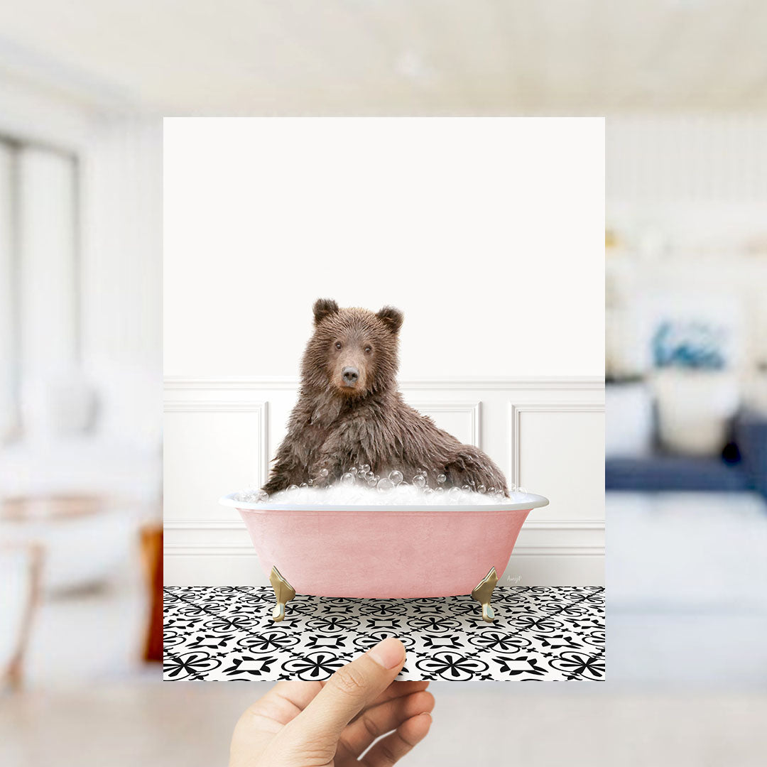 A brown bear sitting in a pink bathtub filled with bubbles, with a black and white patterned floor in the background.
