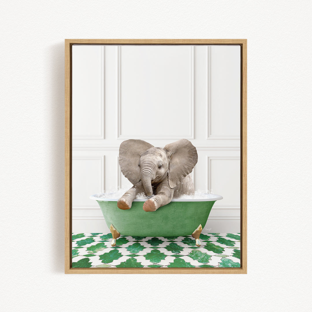 A baby elephant sitting in a green bathtub filled with water, surrounded by a patterned green and white floor.