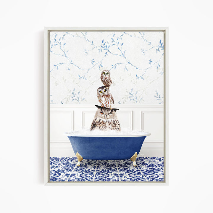 A framed image depicting a group of owls sitting in a blue bathtub, with a patterned tile floor and a floral wallpaper in the background.