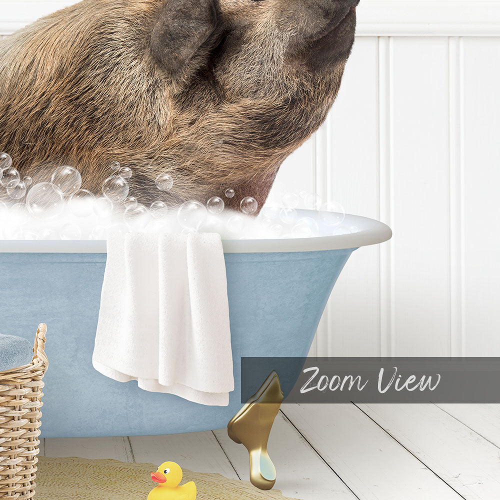 A pig is sitting in a blue bathtub filled with bubbles, surrounded by a yellow rubber duck and a white towel.