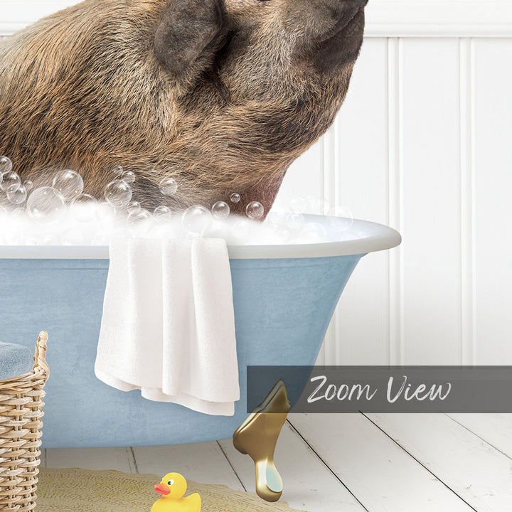A pig is sitting in a blue bathtub filled with bubbles, surrounded by a yellow rubber duck and a white towel.