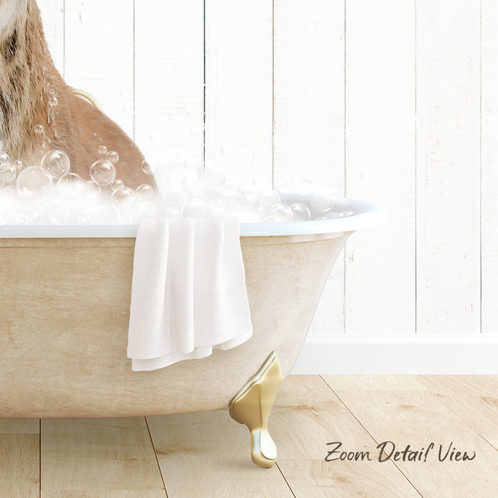 A bathtub filled with bubbles, with a towel and a gold claw-foot design visible.
