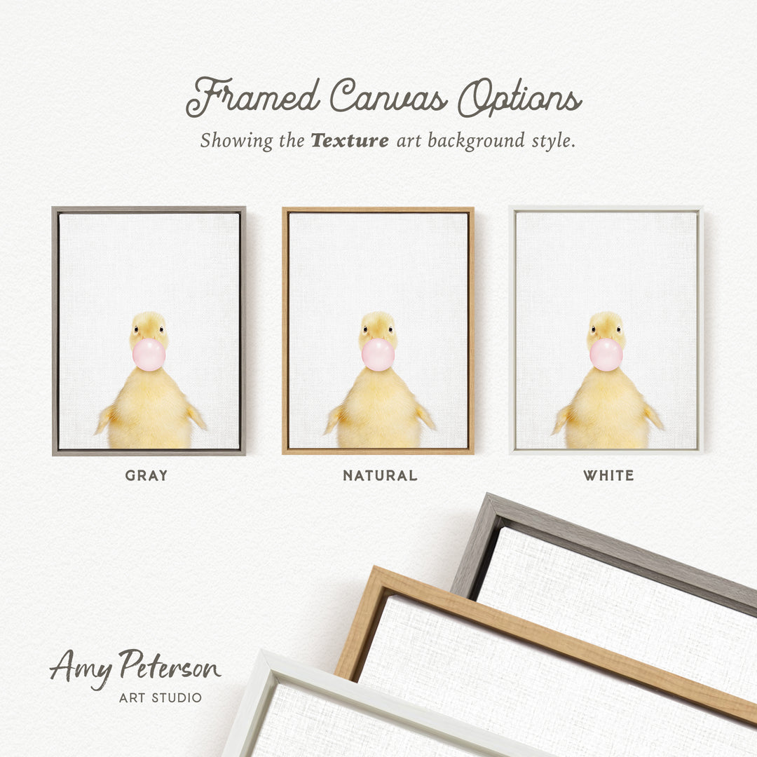 three framed canvas options, each featuring a yellow duck blowing a bubble with a different background color: gray, natural, and white.