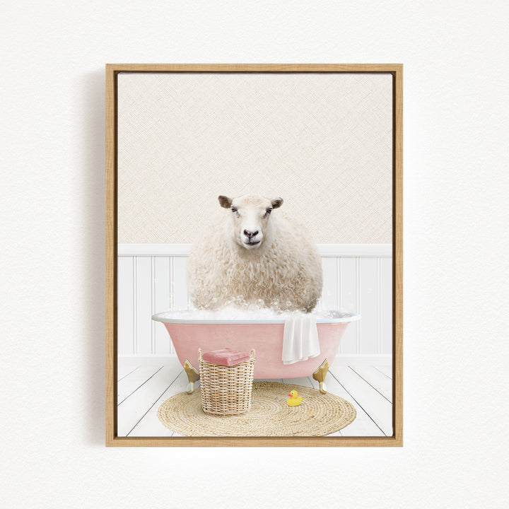 A fluffy white sheep sits in a pink bathtub filled with bubbles, surrounded by a basket of bath toys and a yellow rubber duck.