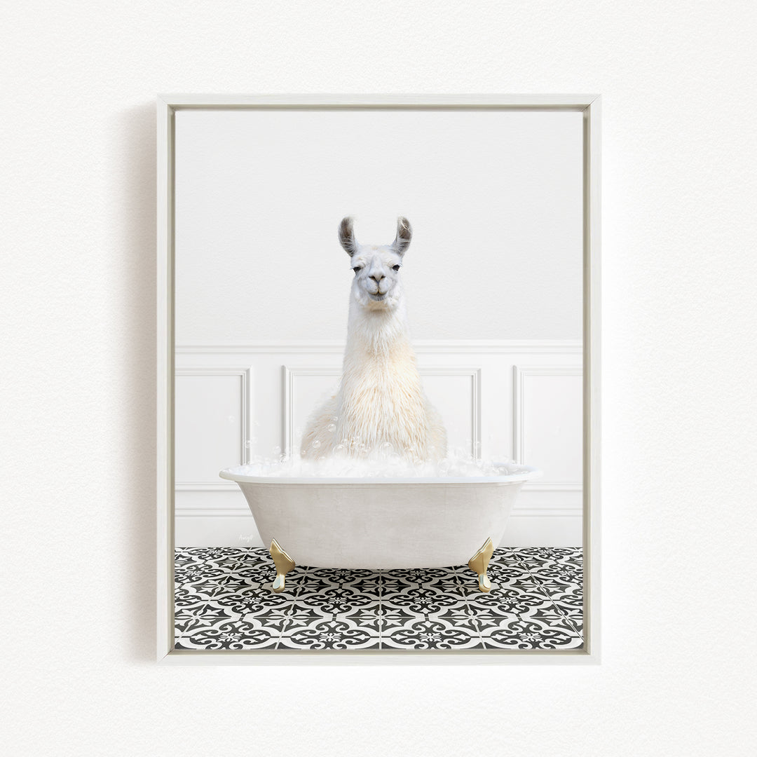 A white llama sitting in a white bathtub filled with bubbles, surrounded by a black and white patterned floor.