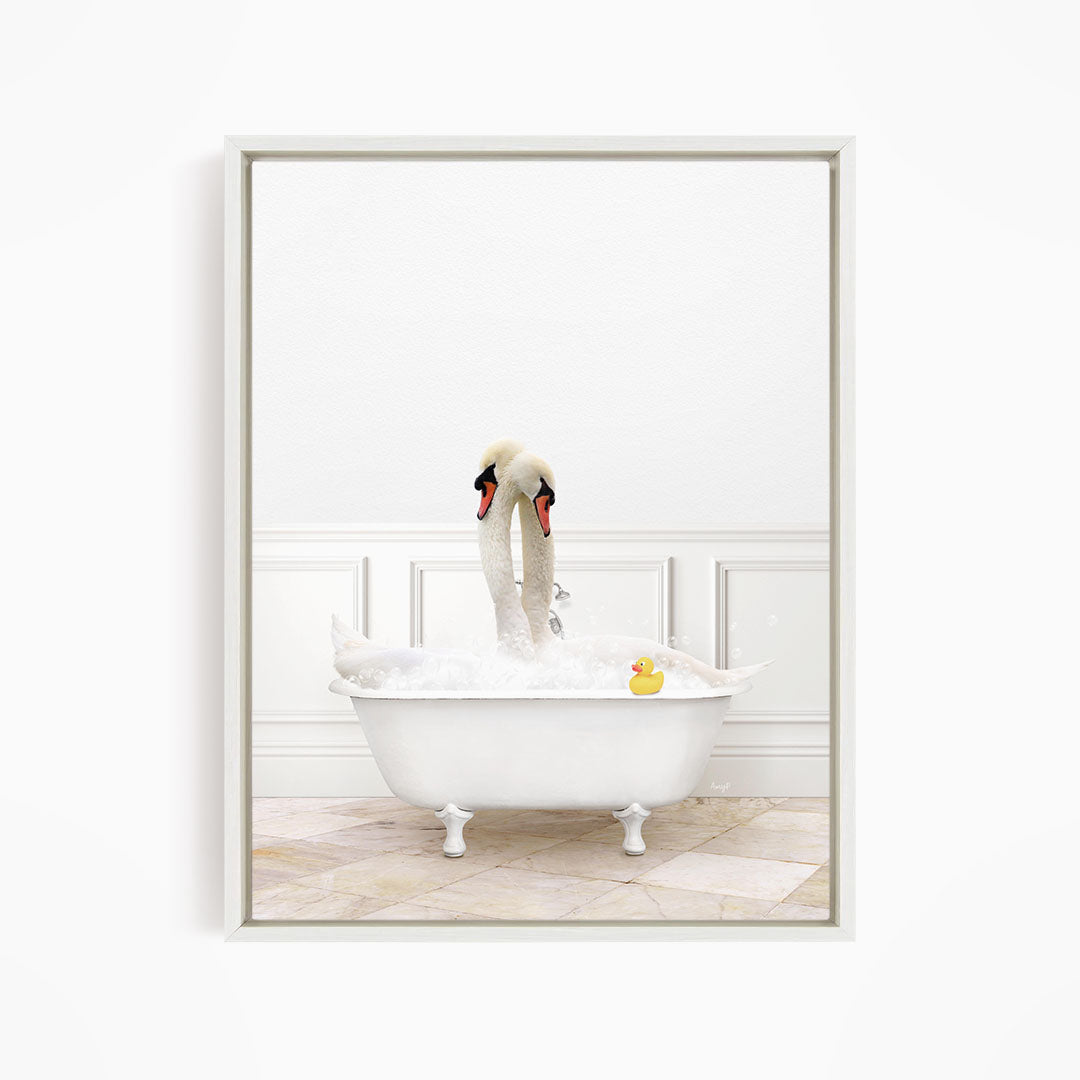 A white swan bathtub filled with water and bubbles, with two swans standing on the edge of the tub and a rubber duck floating in the water.