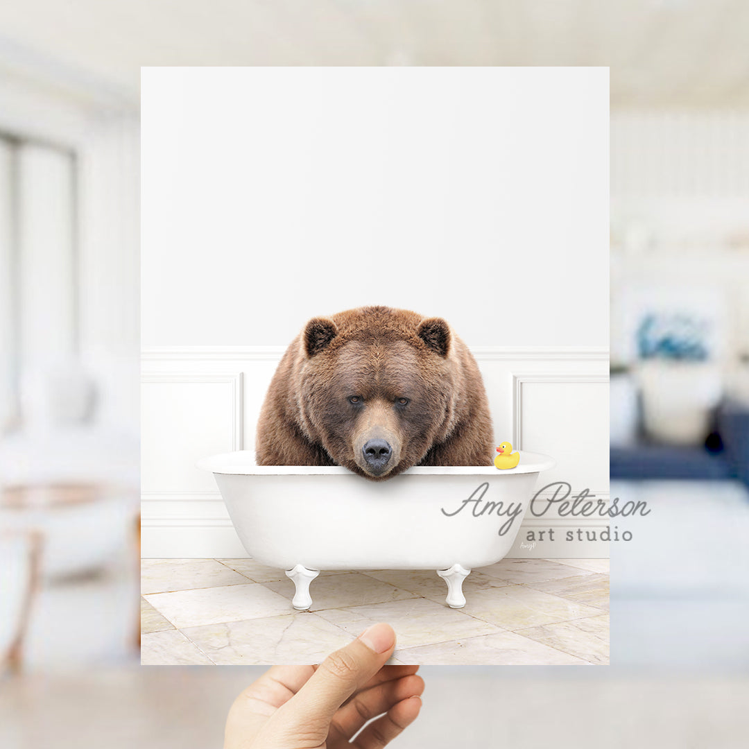 a person holding up a card with a bear in a bathtub