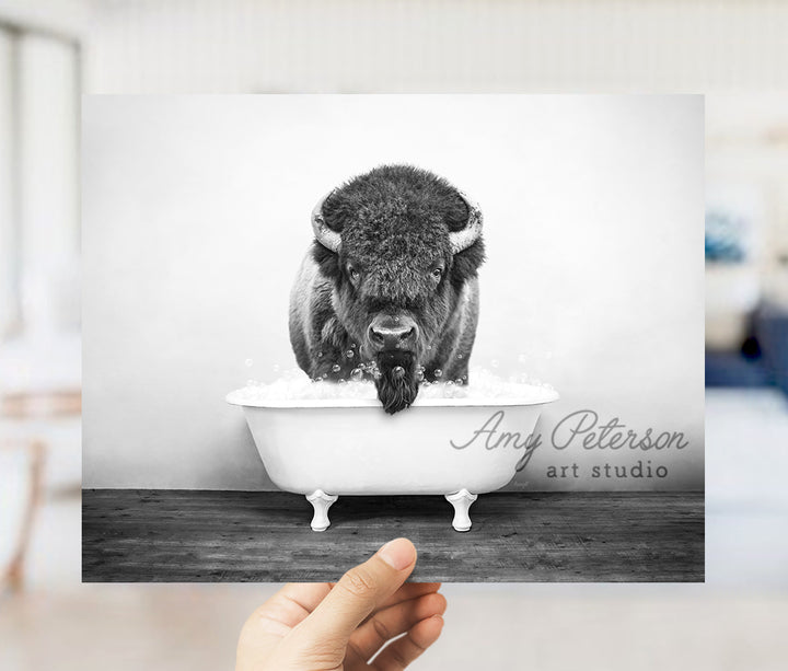 a black and white photo of a bison in a bathtub